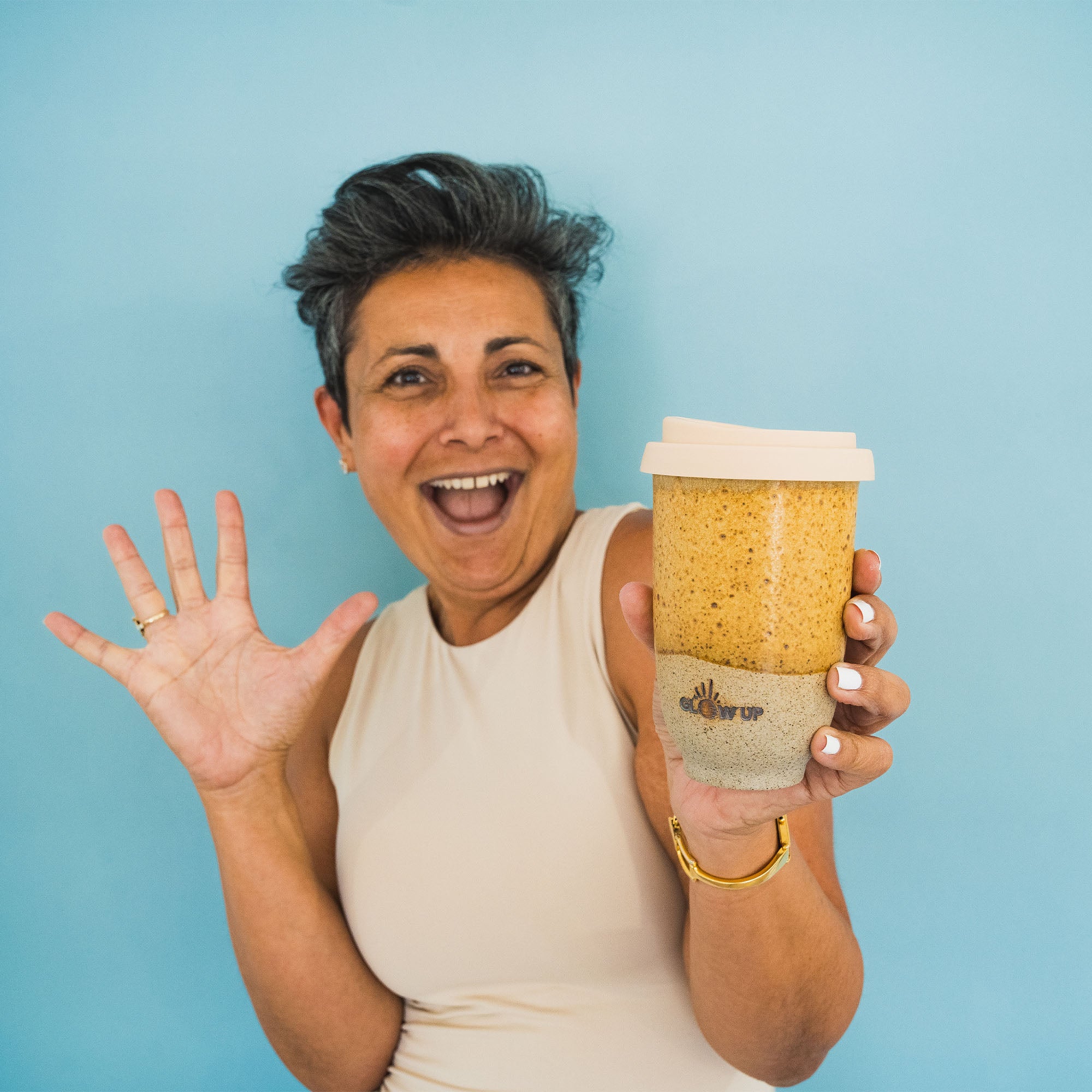 Moodshot holding the lost in new york glow up cup