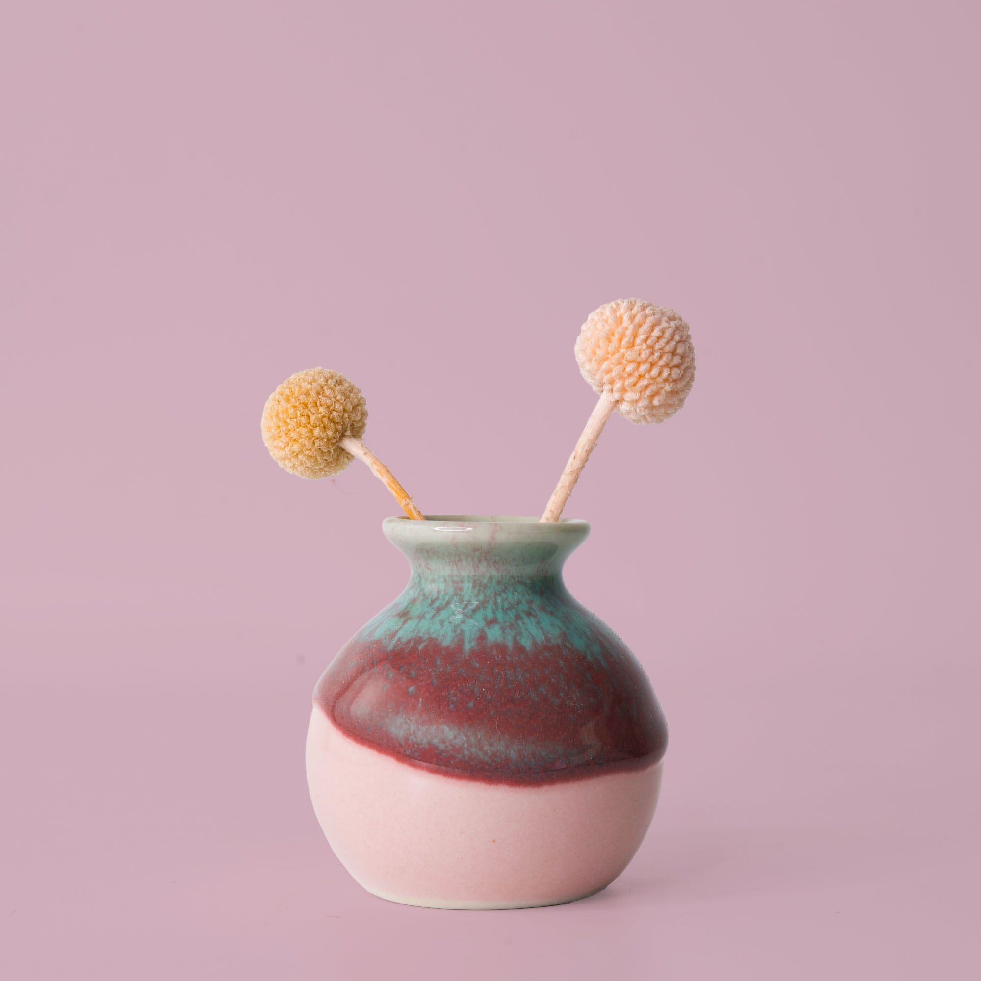 Pottery For The Planet eco-friendly home decor vase with blue and pink glaze holding dried flowers