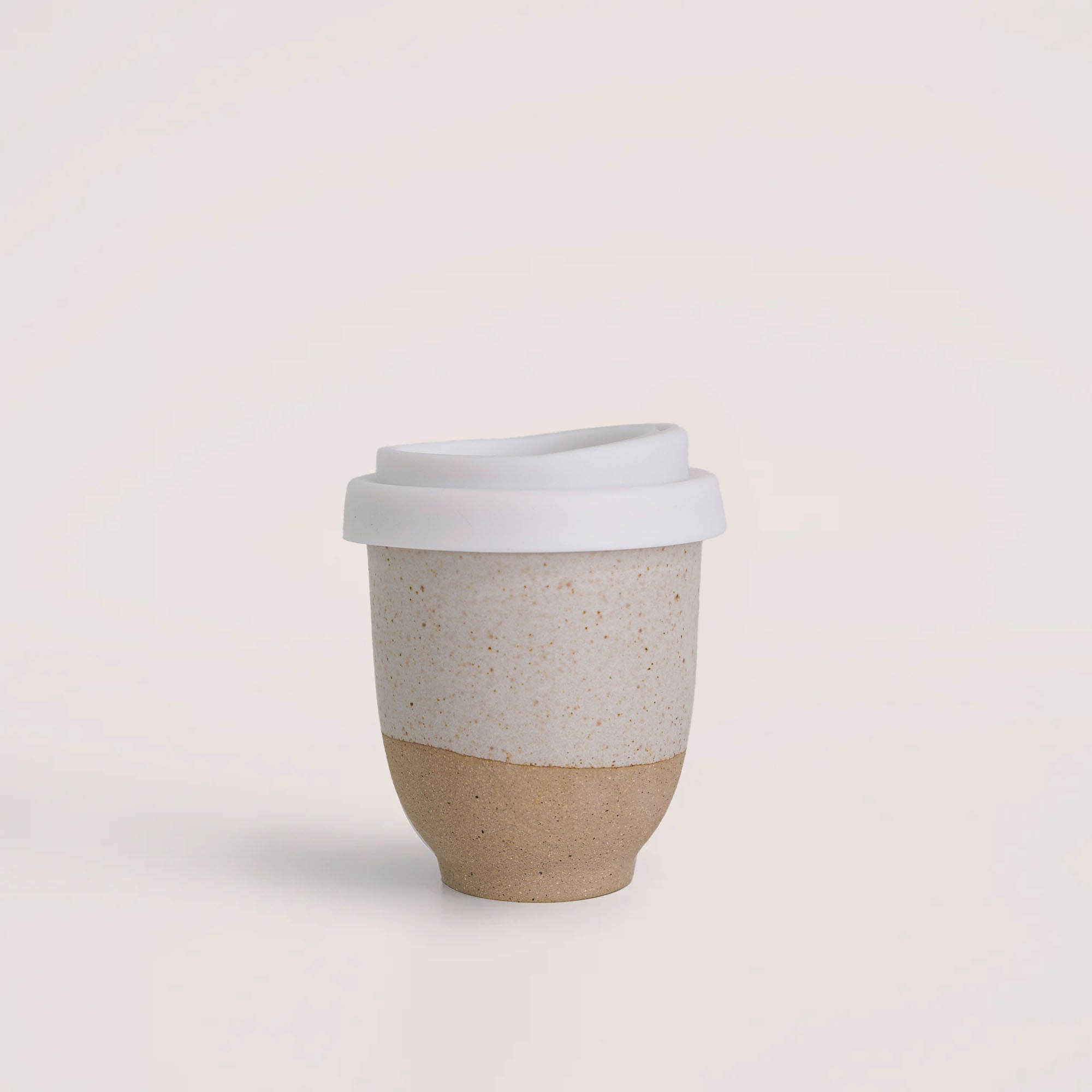 Handmade reusable coffee cup by Pottery For The Planet with beige ceramic and white lid