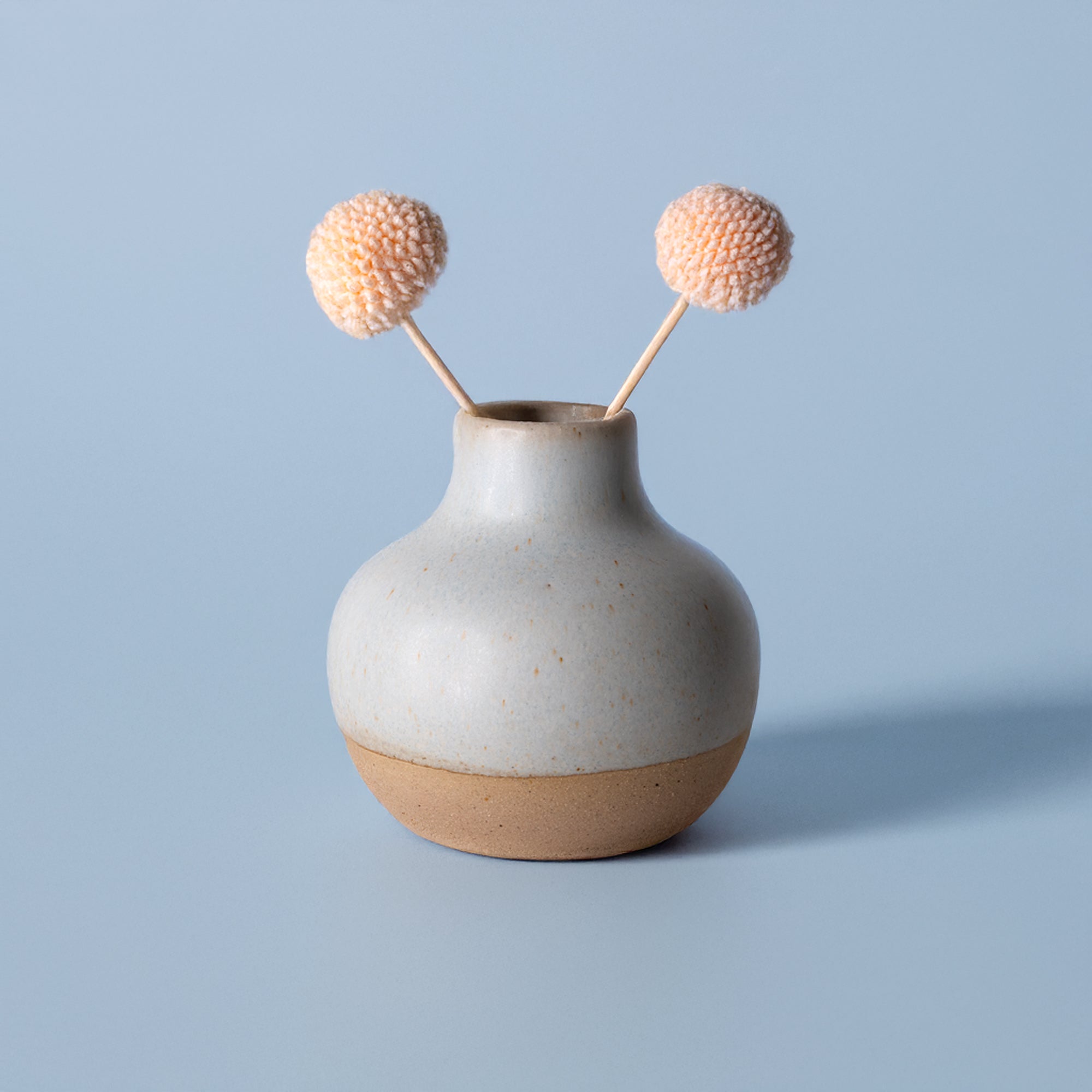 Small handmade home decor vase by Pottery For The Planet with matte finish and decorative dried flowers