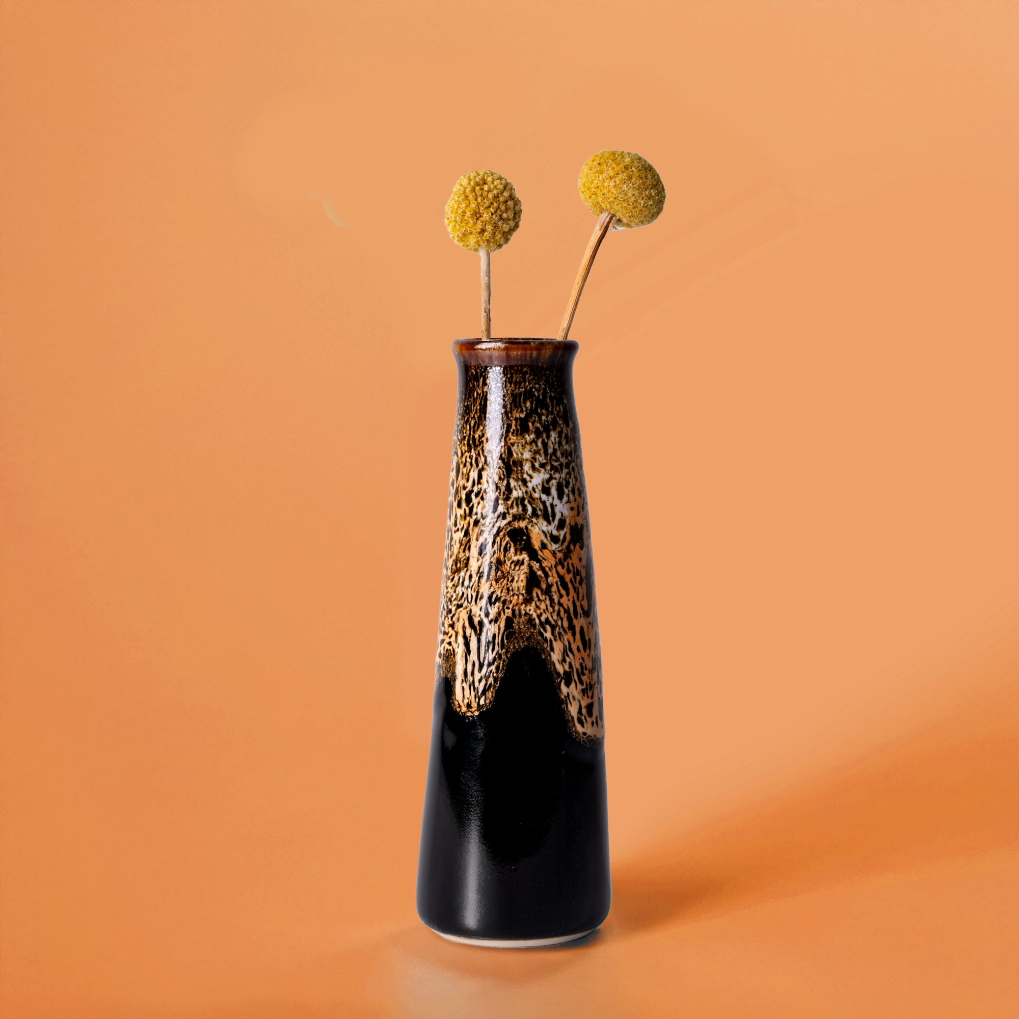Tall Pottery For The Planet sustainable home decor vase with brown and black glaze and yellow billy ball flowers