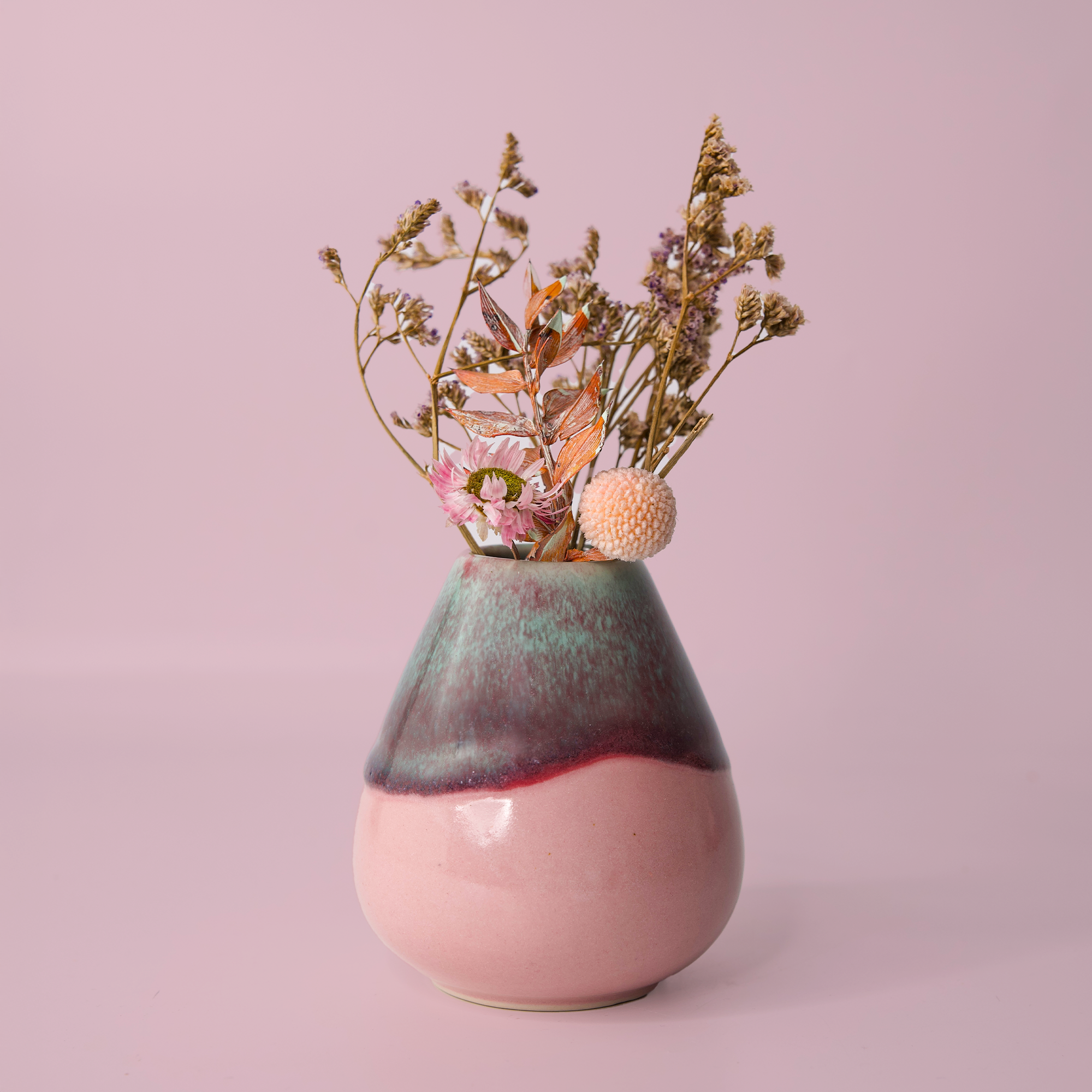 Pottery For The Planet unique pottery flower vase with pink and green glaze holding dried flowers