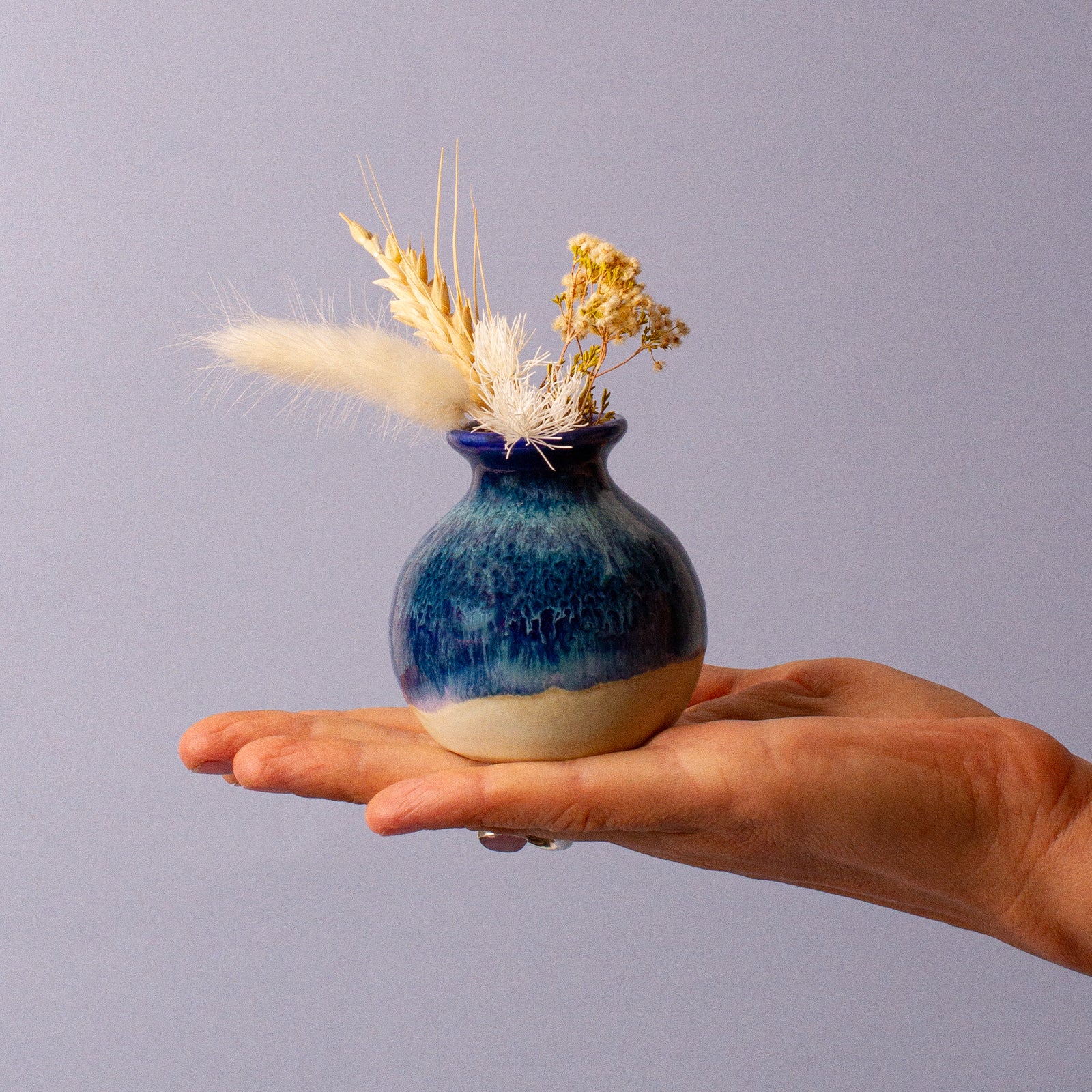 Small Blue Ceramic Vase in Hand