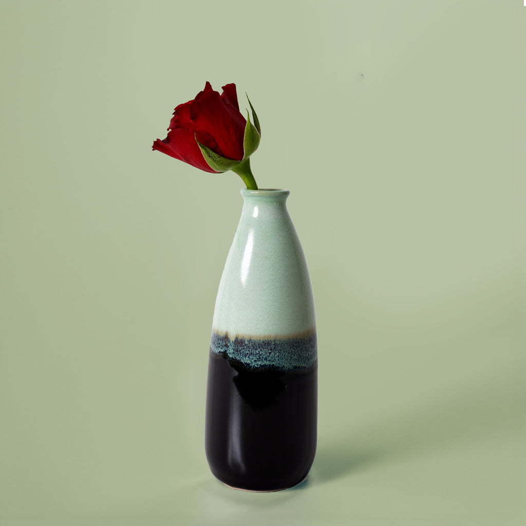 Pottery For The Planet artisan decorative vase for flowers with light green and black glaze holding a red rose
