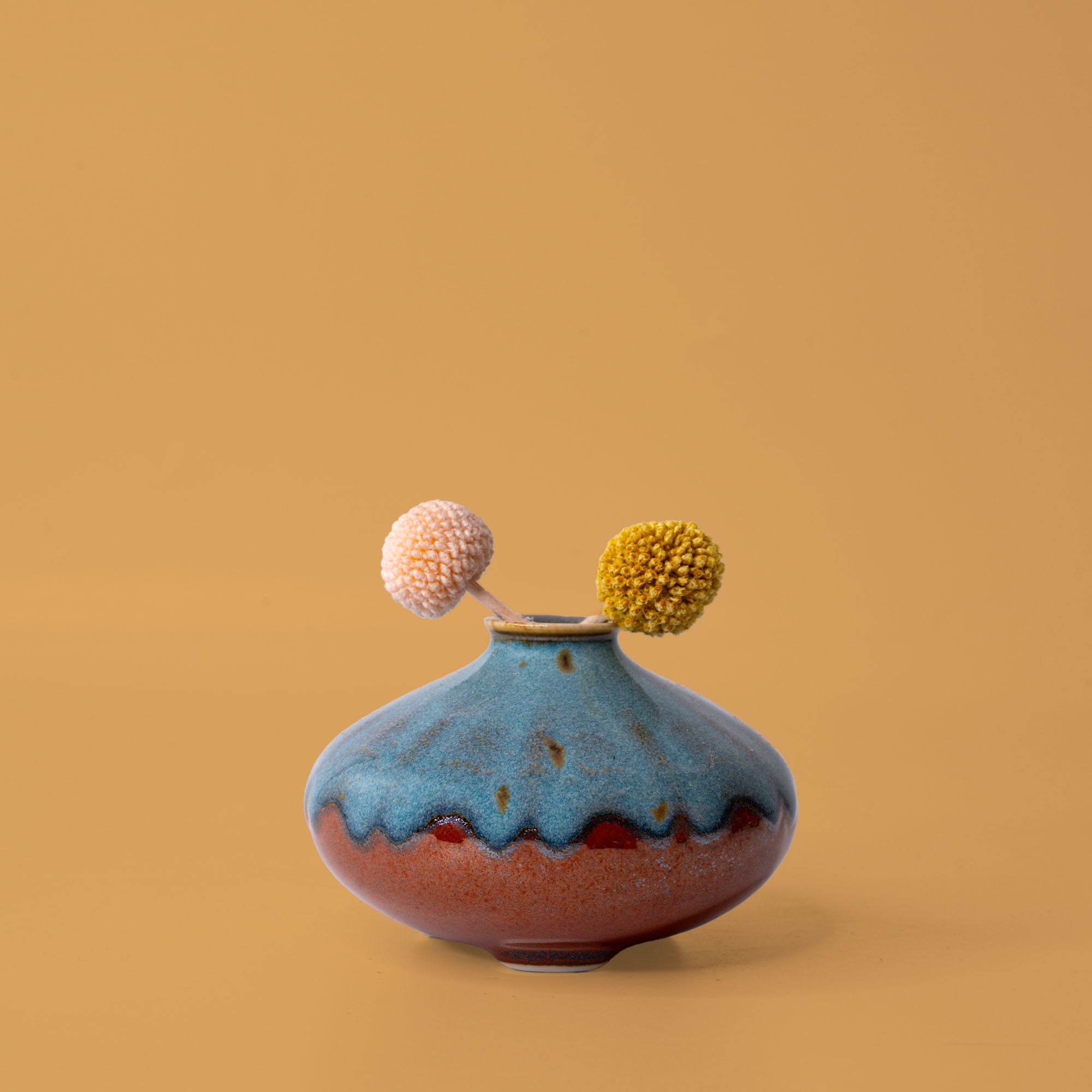 Pottery For The Planet artisan decorative vases in blue and brown with dried floral accents