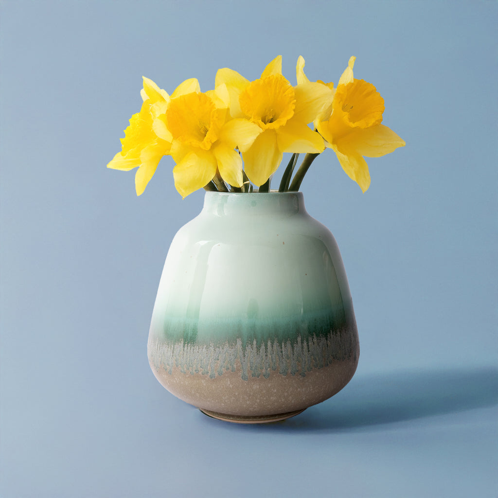 Pottery For The Planet ceramic bouquet vase for home decor with green and beige glaze holding yellow flowers