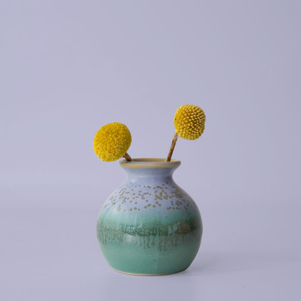 Pottery For The Planet eco-friendly home decor vase in green and blue with yellow dried flowers