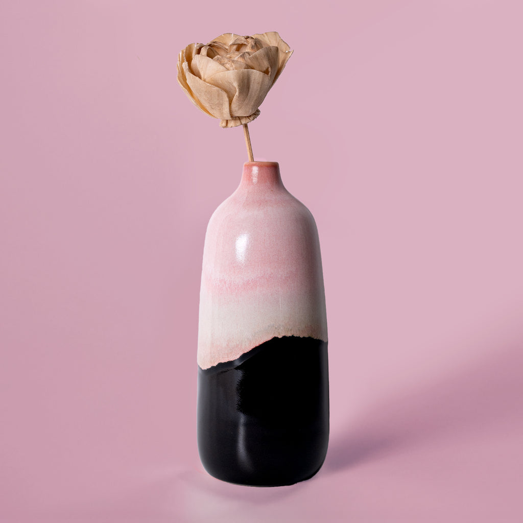 Pink and black ceramic eco-friendly home decor vase from Pottery For The Planet with dried flower