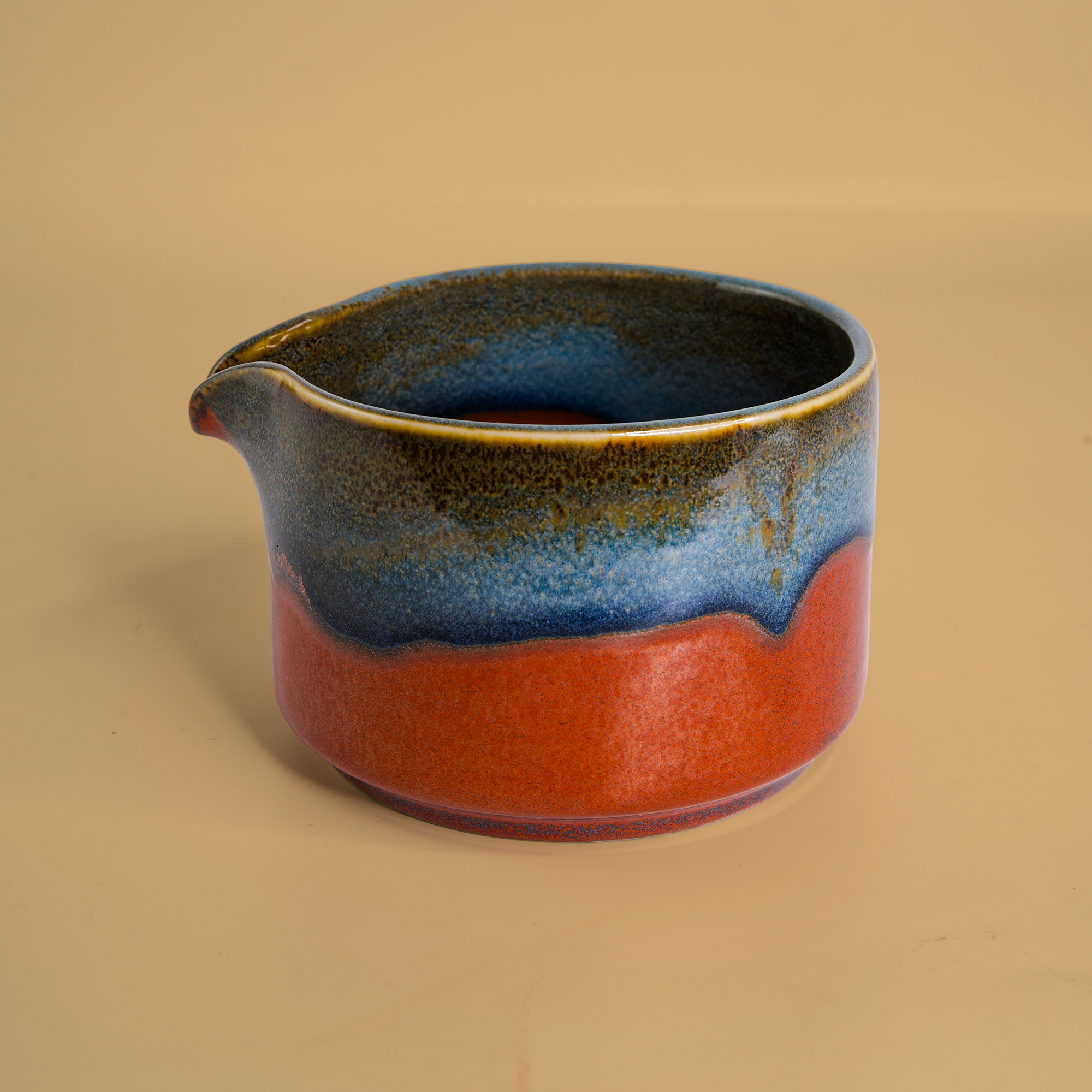 Handcrafted matcha bowl with blue and red glaze by Pottery For The Planet for tableware