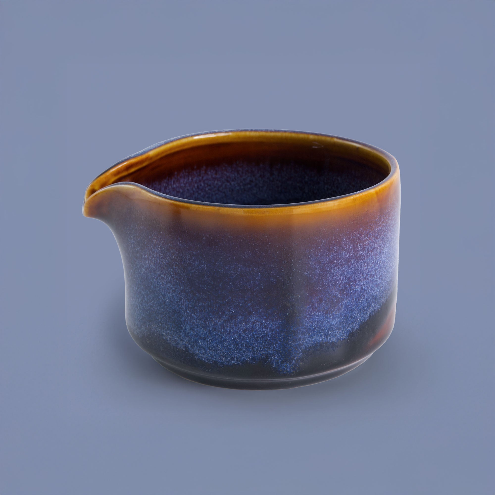 Pottery For The Planet handcrafted matcha bowl with blue and brown gradient glaze and pouring spout