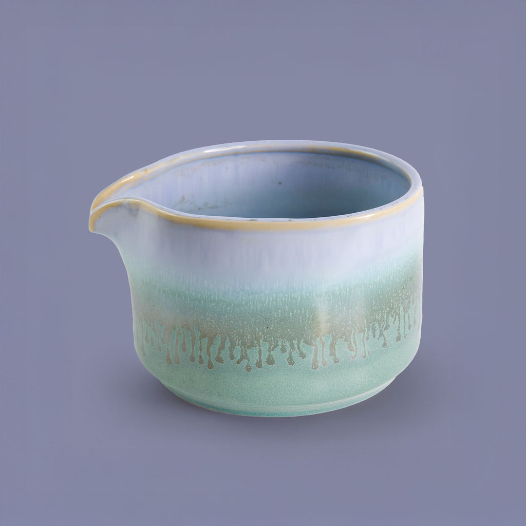 Handcrafted matcha bowl with green and white glaze featuring a pouring spout by Pottery For The Planet
