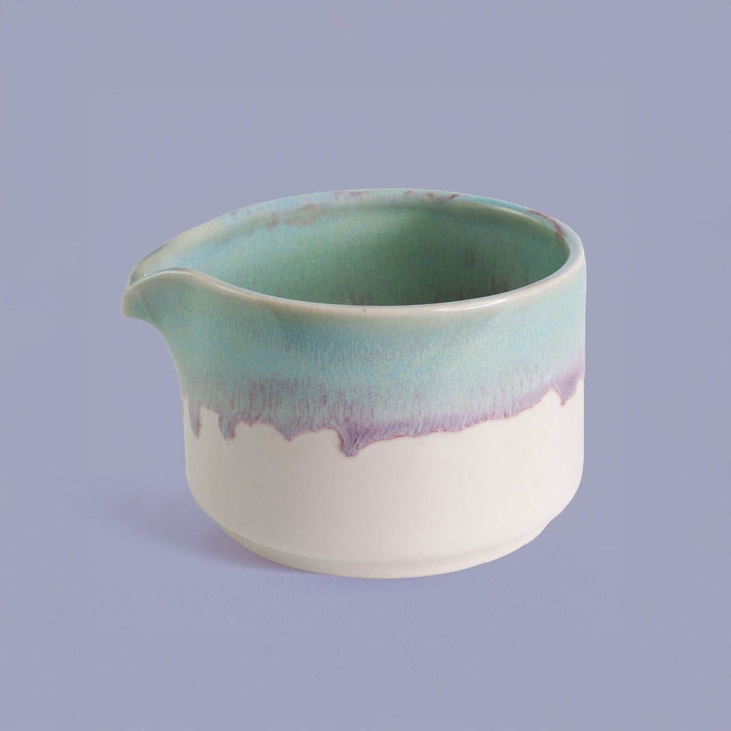 Handcrafted matcha bowl with green and purple glaze by Pottery For The Planet