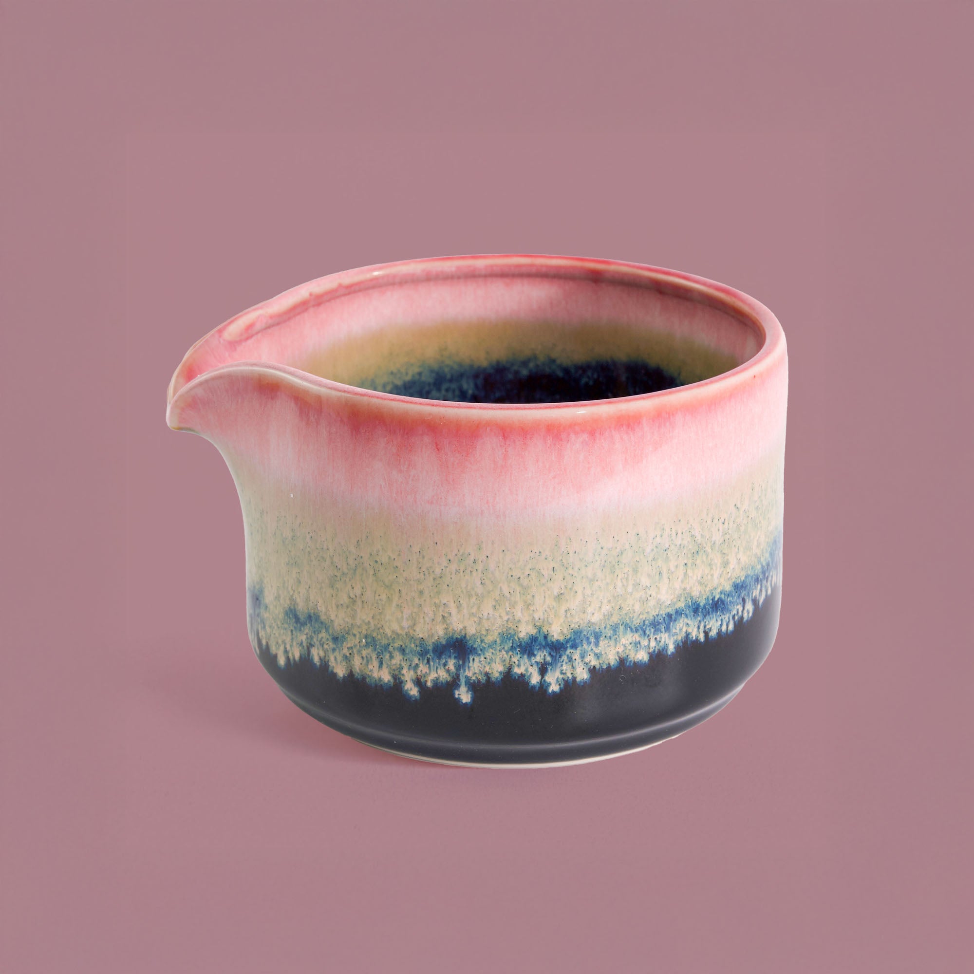 Pottery For The Planet handcrafted matcha bowl with pink, beige, and blue glaze and pouring spout