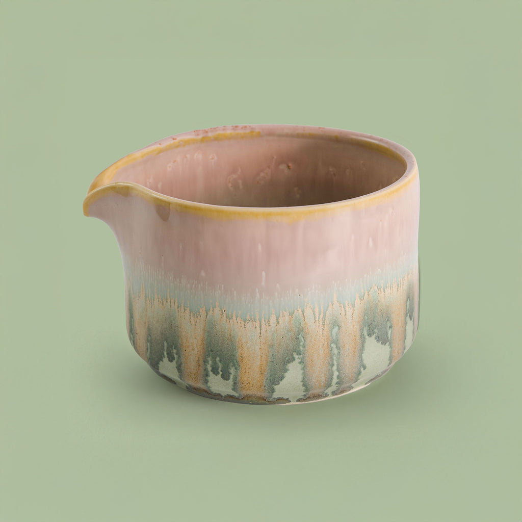 Handcrafted matcha bowl with pink and green glaze and a spout for easy pouring