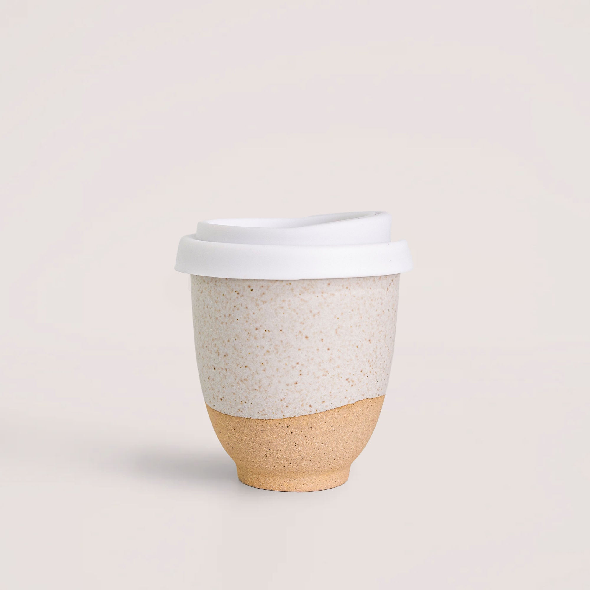 Pottery For The Planet handmade reusable coffee cup with white lid and two-tone ceramic design