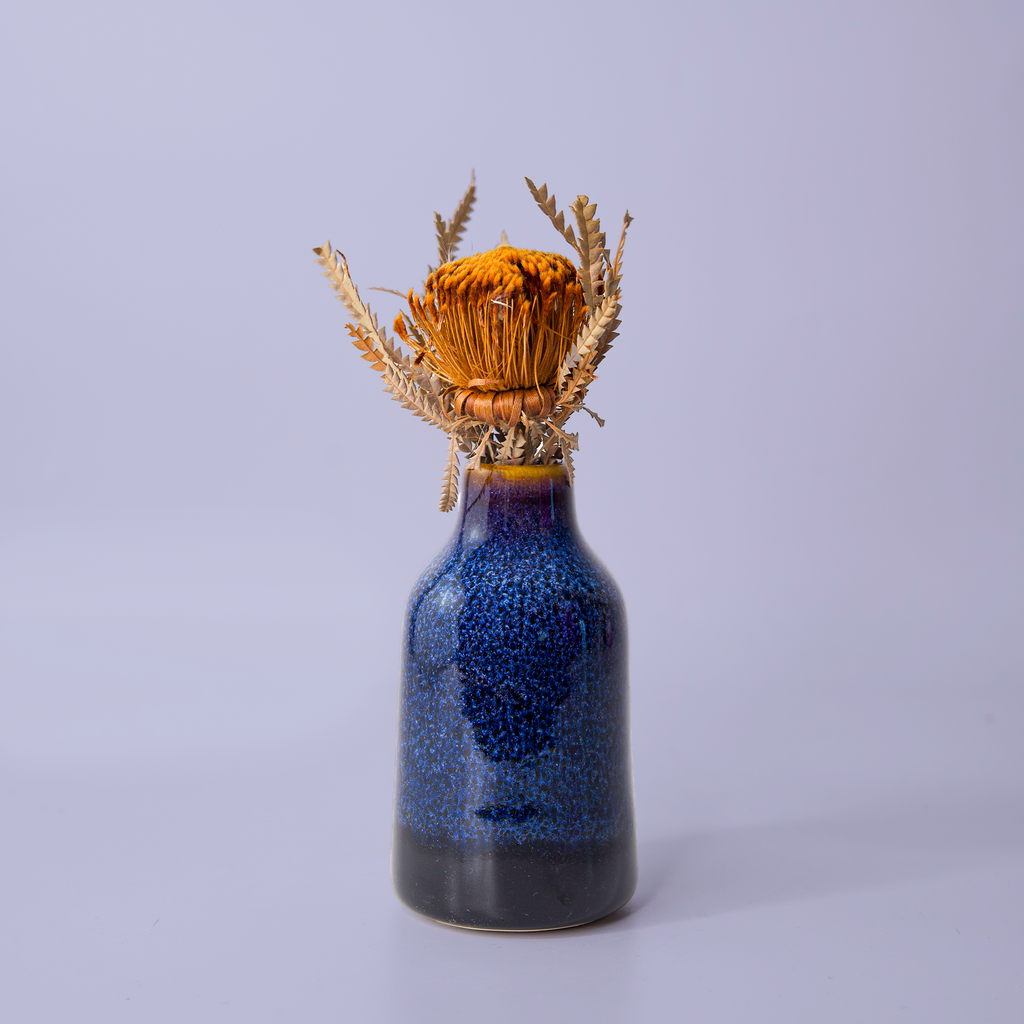 Blue ceramic modern decorative flower vase by Pottery For The Planet with dried orange flower arrangement