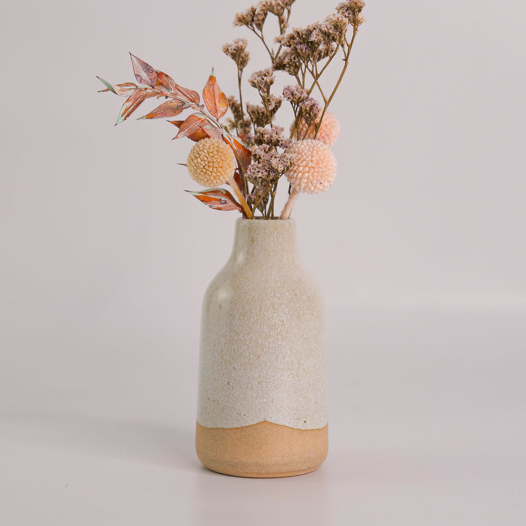 Modern decorative flower vase by Pottery For The Planet with a beige and natural texture holding dried flowers