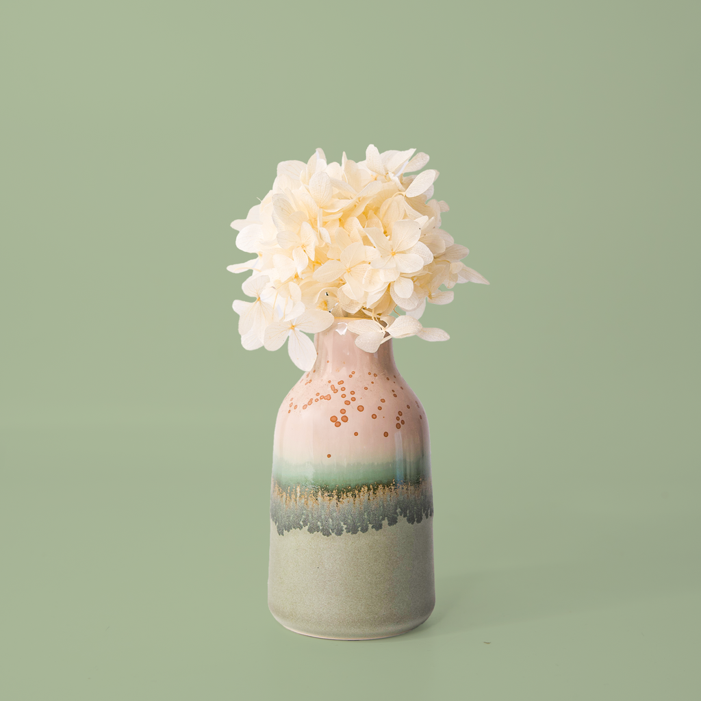Modern decorative flower vase by Pottery For The Planet with pink green and beige glaze holding white flowers