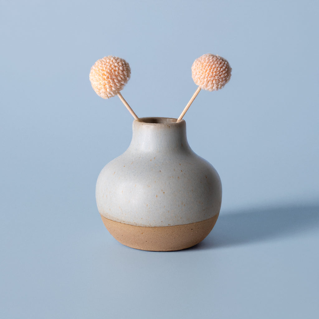 Small handmade home decor vase by Pottery For The Planet with matte finish and decorative dried flowers