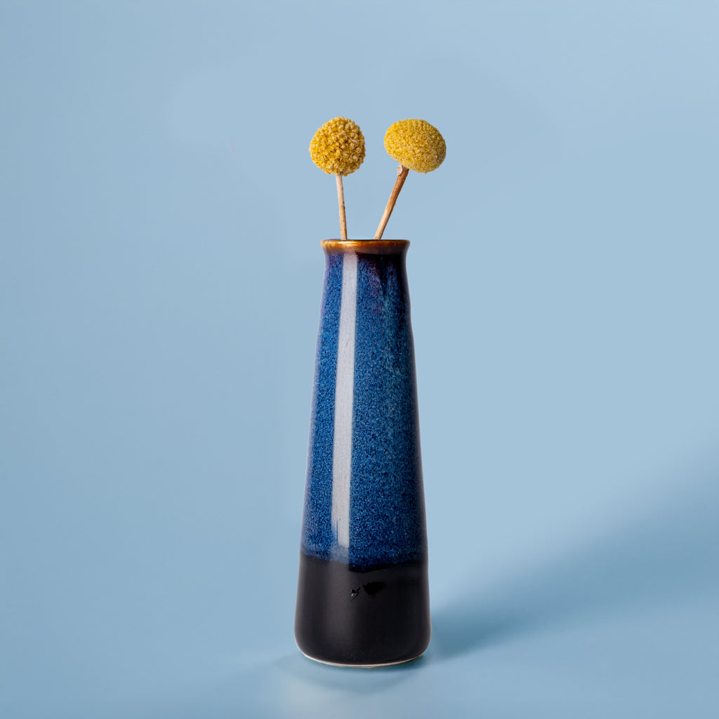 Pottery For The Planet tall blue and black sustainable home decor vase with dried yellow flowers