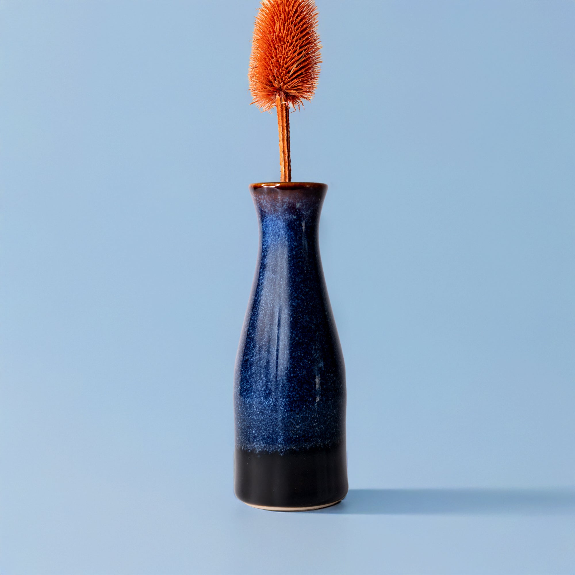 Pottery For The Planet unique ceramic flower vase in blue and black glaze with dried orange flower