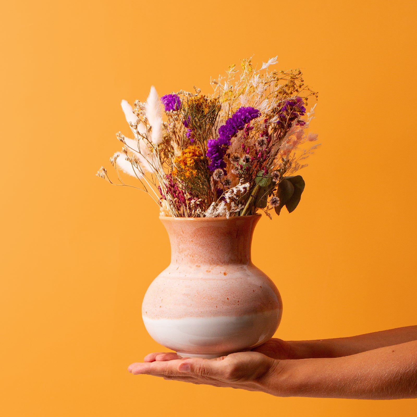 Red and white ceramic vase in Hand